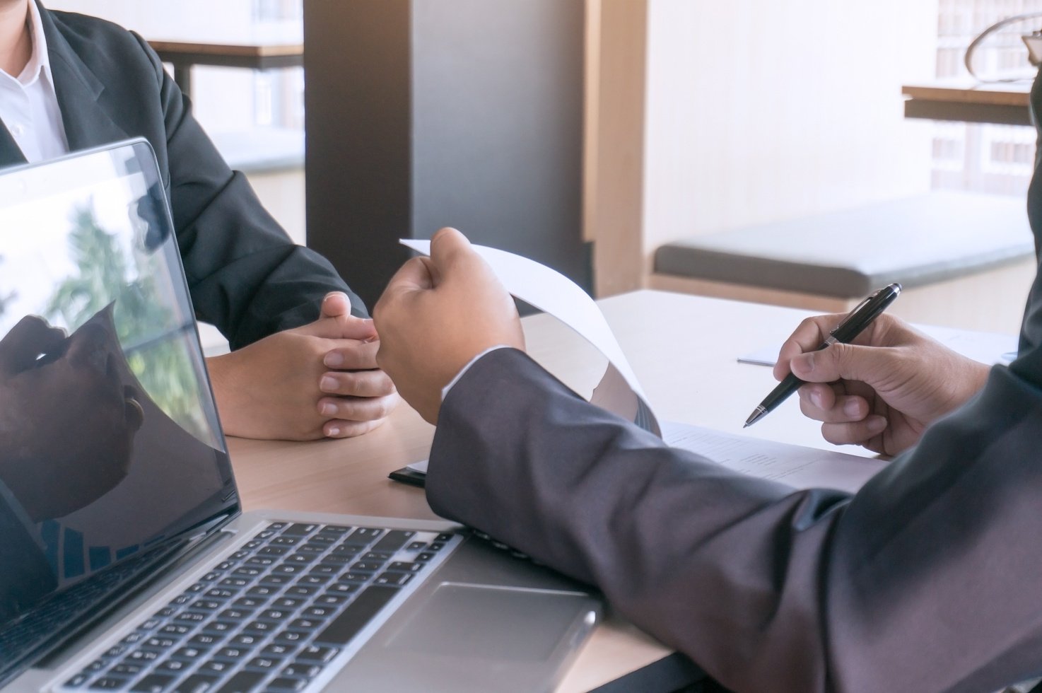 Examiner Reading a Resume during  Job Interview at Office Busine